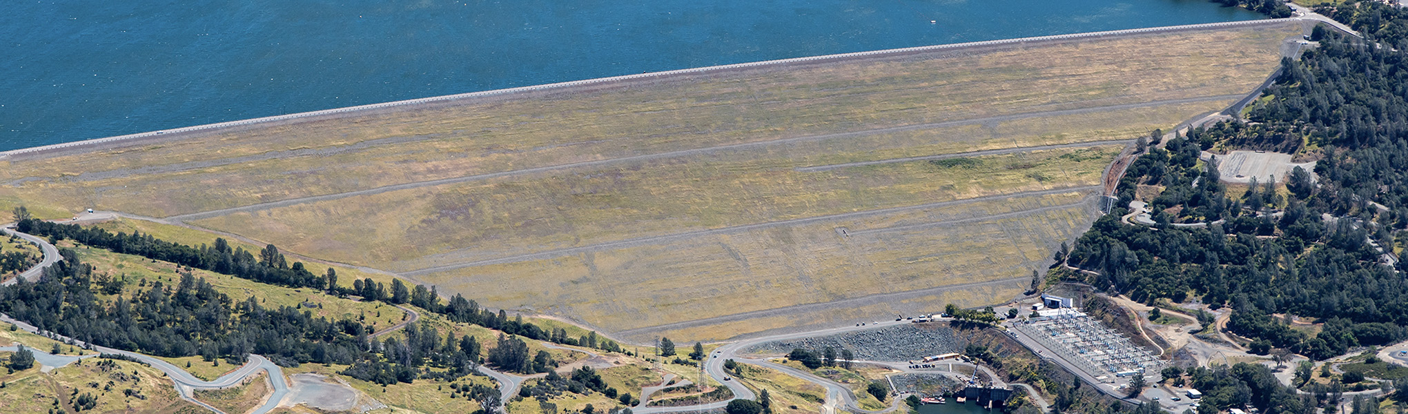 Oroville Dam as see from an elevated downstream perspective.